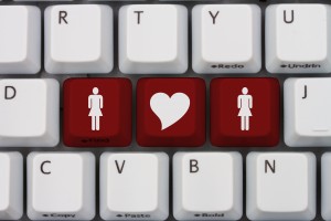 Online Dating, A gray computer keyboard with woman and woman symbol with a heart in red letters