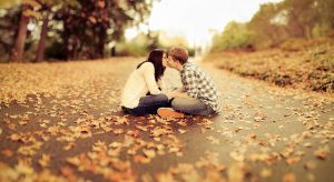 virgin couple kissing on autumn leaves