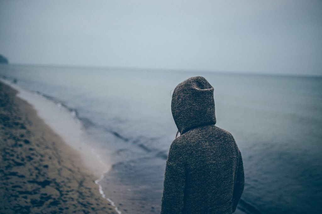 Lonely person walking on a beach